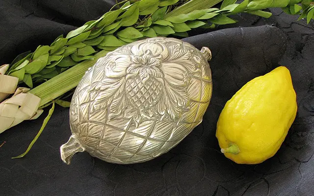 Etrog (citron fruit), silver etrog box and the lulav (willow, myrtle, and palm) used in the 4 species ceremony.