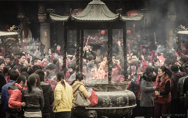 People burning incense sticks as a part of a ritual on the first day of the Chinese New Year Festival.