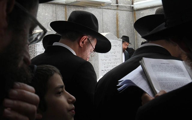 Jewish faithful reading blessings related to the celebration of Sukkot.