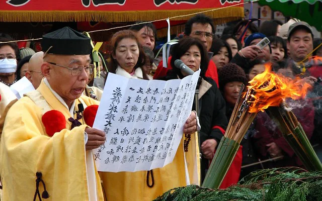 A Shinto priest (kannushi) reads blessings during the bean-throwing ceremony at a temple.