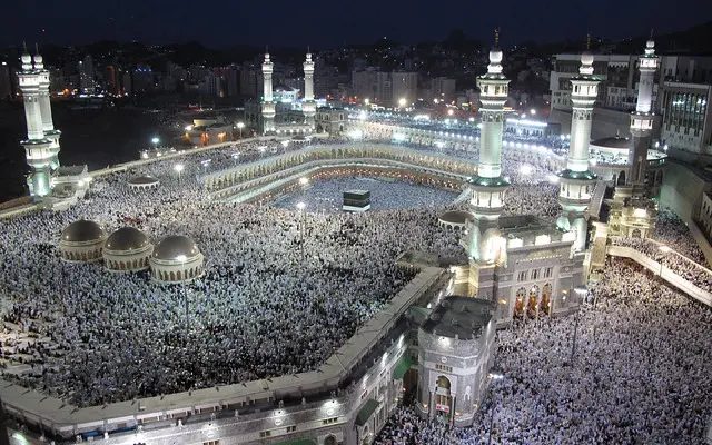 A panoramic image showing huge crowds of pilgrims flooding the Great Mosque of Mecca for the night prayer.