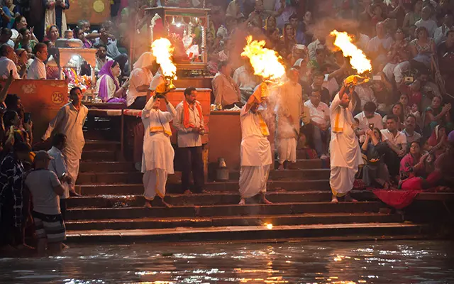 A night-process of believers worshiping Goddess Durga, reaches the river bank of the city.