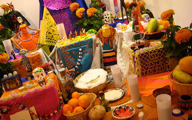 A decorated altar that contains a series of items and objects honoring the spirits of the Day of the Dead.