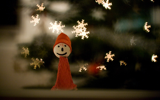 A Christmas snowman clothed in red implicating Santa's outfit.