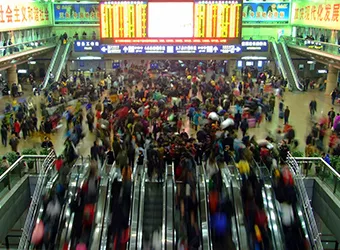 Crowds travelling through Beijing railway station.