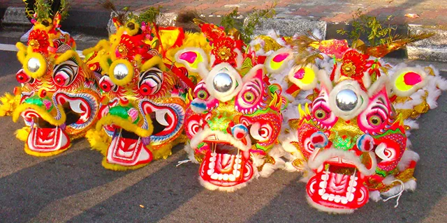 Lion head-masks laying on the floor before the start of the New Year parade event.