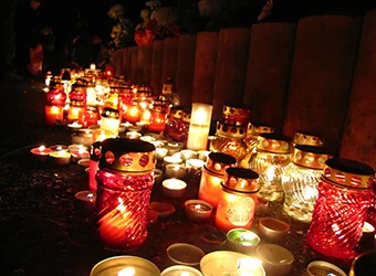 Numerous lit candles in a catholic cemetery.