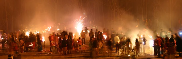 A group of people taking part in a neighborhood-level organized firework event during Diwali.