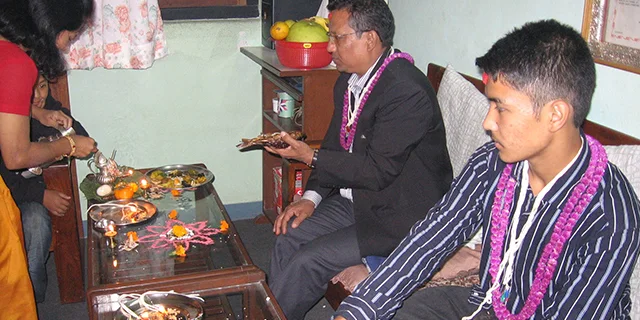 Members of the Newar populations performing a ritual during Diwali celebration in a Nepalese household.