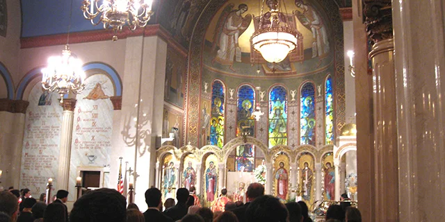 Faithful attending an Easter liturgy during the Great Week in a Greek Orthodox church.