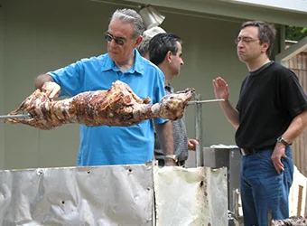 Greeks roasting the traditional Easter lamb.