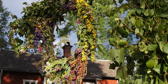 A floral wreath as a decoration of a typical Swedish summer house.
