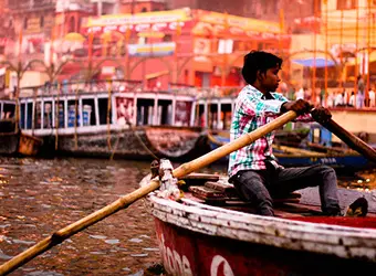 A boy rowing a boat, Agra, Uttar Pradesh.