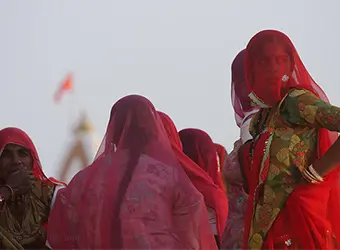Women pilgrims dressed in red color.