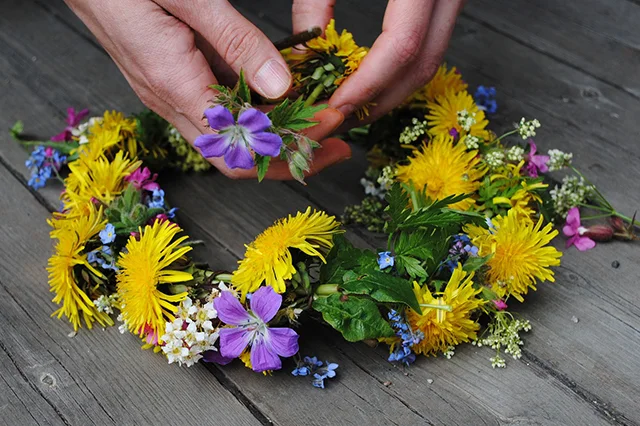 Making a colorful flower wreath.