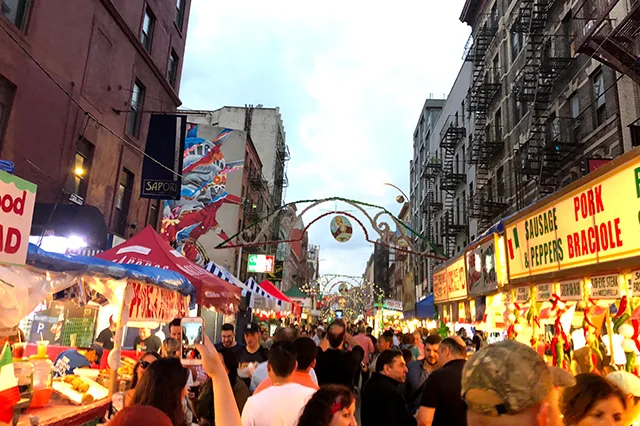 Crowds and numerous street vendors along Mulberry Street during the Feast of San Gennaro.