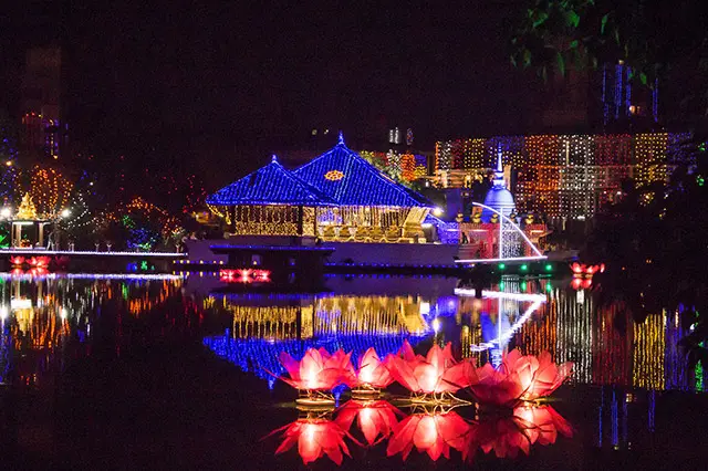 A night picture showing spectacular Vesak decorations reflecting on the water surface.
